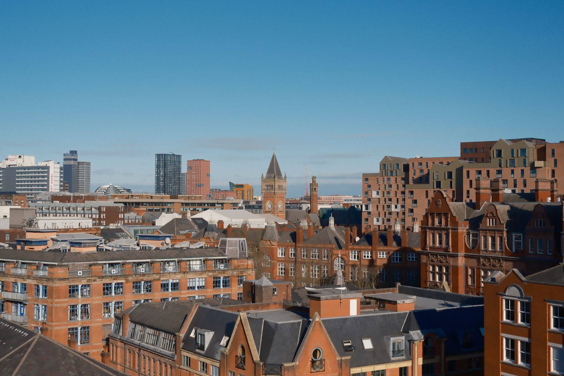 Panoramic view across Manchester’s red-brick rooftops and city skyline